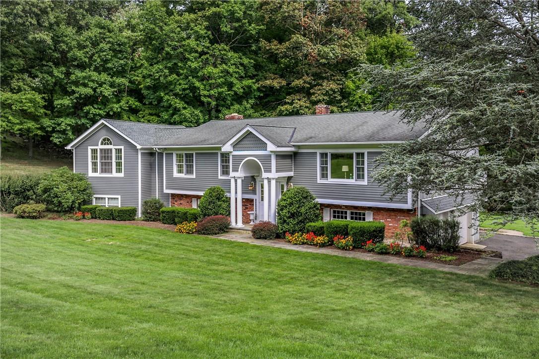 a front view of a house with a garden and plants