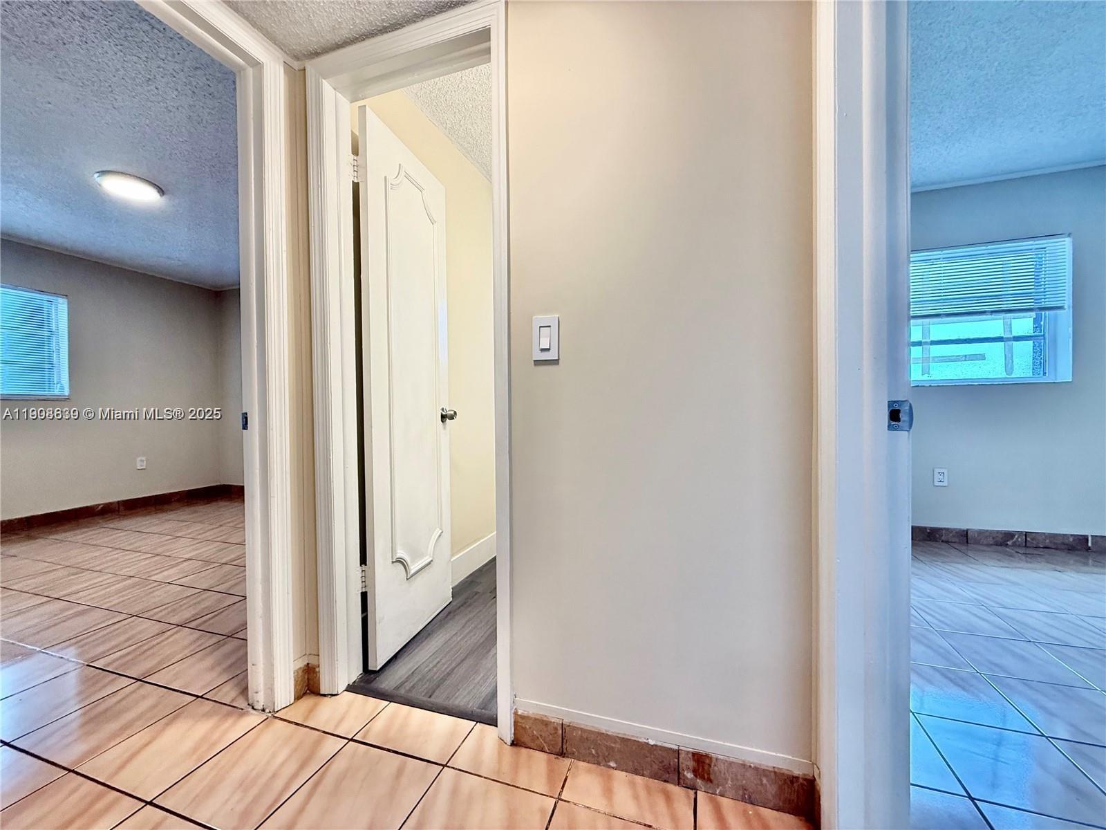 424 Southwest 7th Street, Unit 404 Miami, FL 33130 - Photo 6 of 10 a view of a hallway with wooden floor and closet