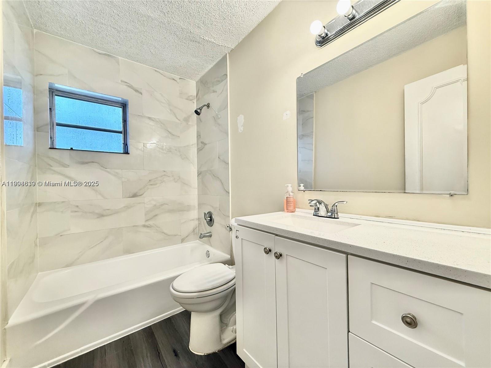 424 Southwest 7th Street, Unit 404 Miami, FL 33130 - Photo 7 of 10 a bathroom with a sink a toilet and shower