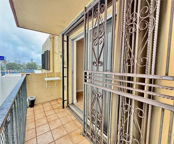 a view of a porch with wooden floor and iron stairs