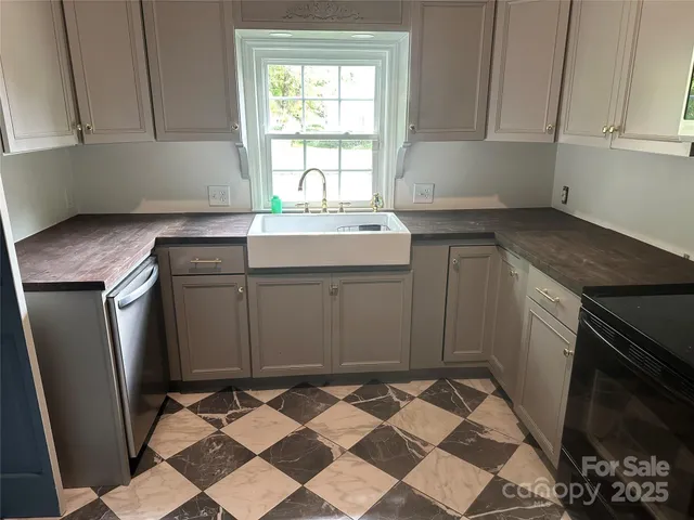 a kitchen with a stove a sink and a refrigerator