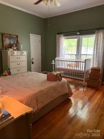 a bed sitting in a bedroom next to a window