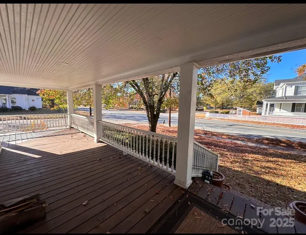 a view of a balcony with wooden floor