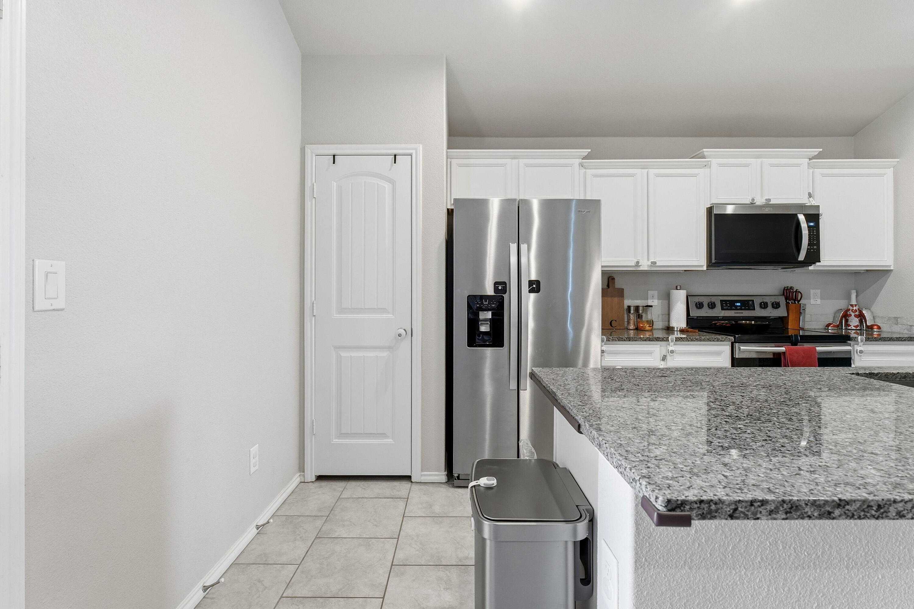 6827 39th Street Lubbock, TX 79407 - Photo 11 of 25 a view of a kitchen with granite countertop a refrigerator and a sink