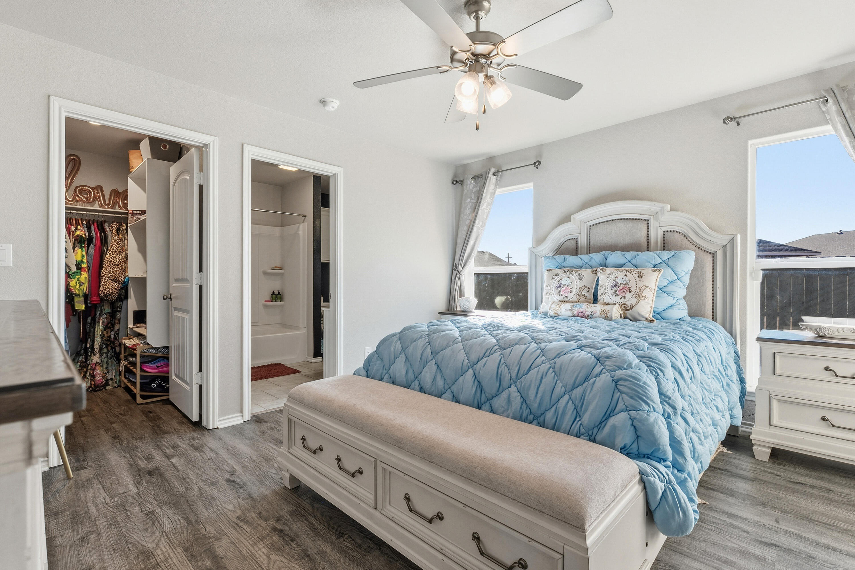 6827 39th Street Lubbock, TX 79407 - Photo 13 of 25 a bedroom with a bed and a chandelier