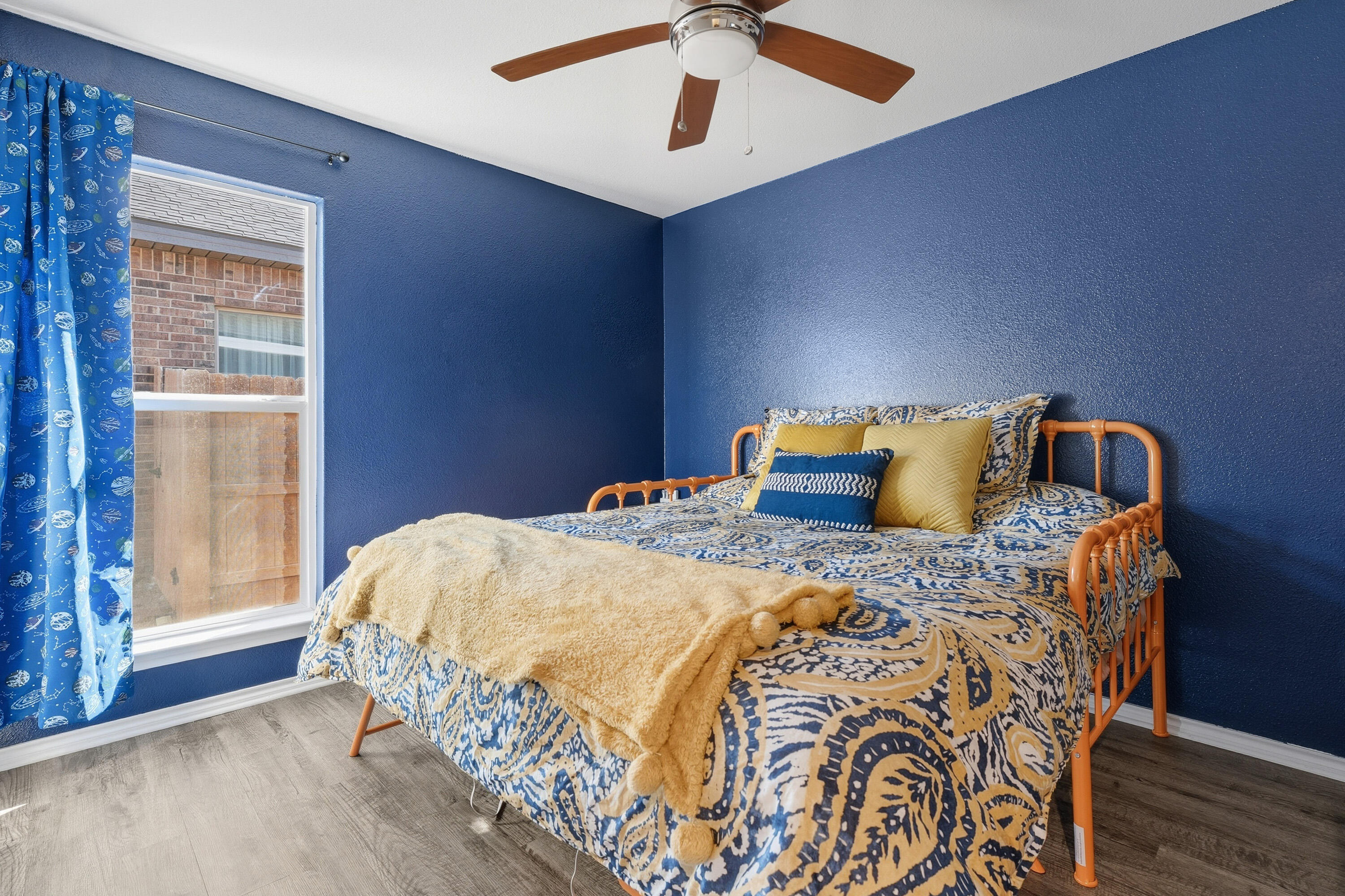 6827 39th Street Lubbock, TX 79407 - Photo 16 of 25 a bedroom with a bed and wooden floor