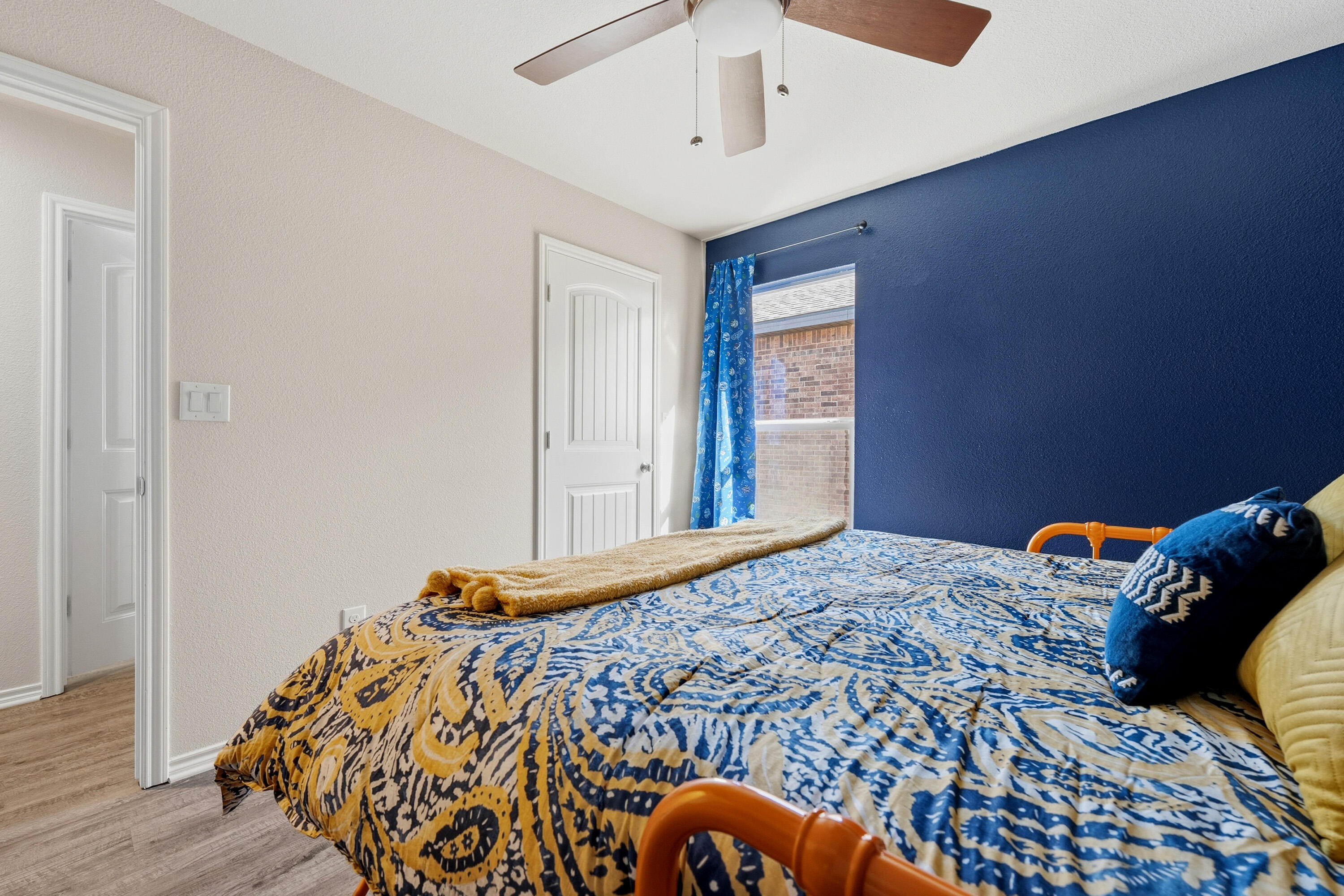 6827 39th Street Lubbock, TX 79407 - Photo 17 of 25 a bedroom with a bed and wooden floor