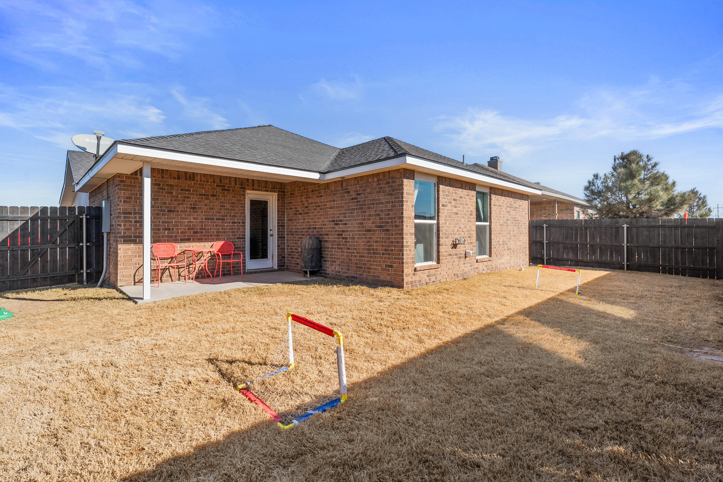 6827 39th Street Lubbock, TX 79407 - Photo 24 of 25 a front view of a house with a yard and garage