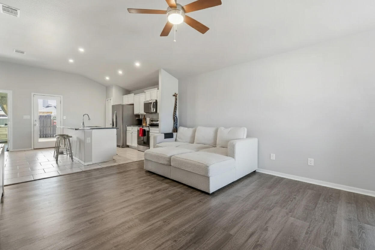 6827 39th Street Lubbock, TX 79407 - Photo 4 of 25 a living room with furniture and a view of kitchen