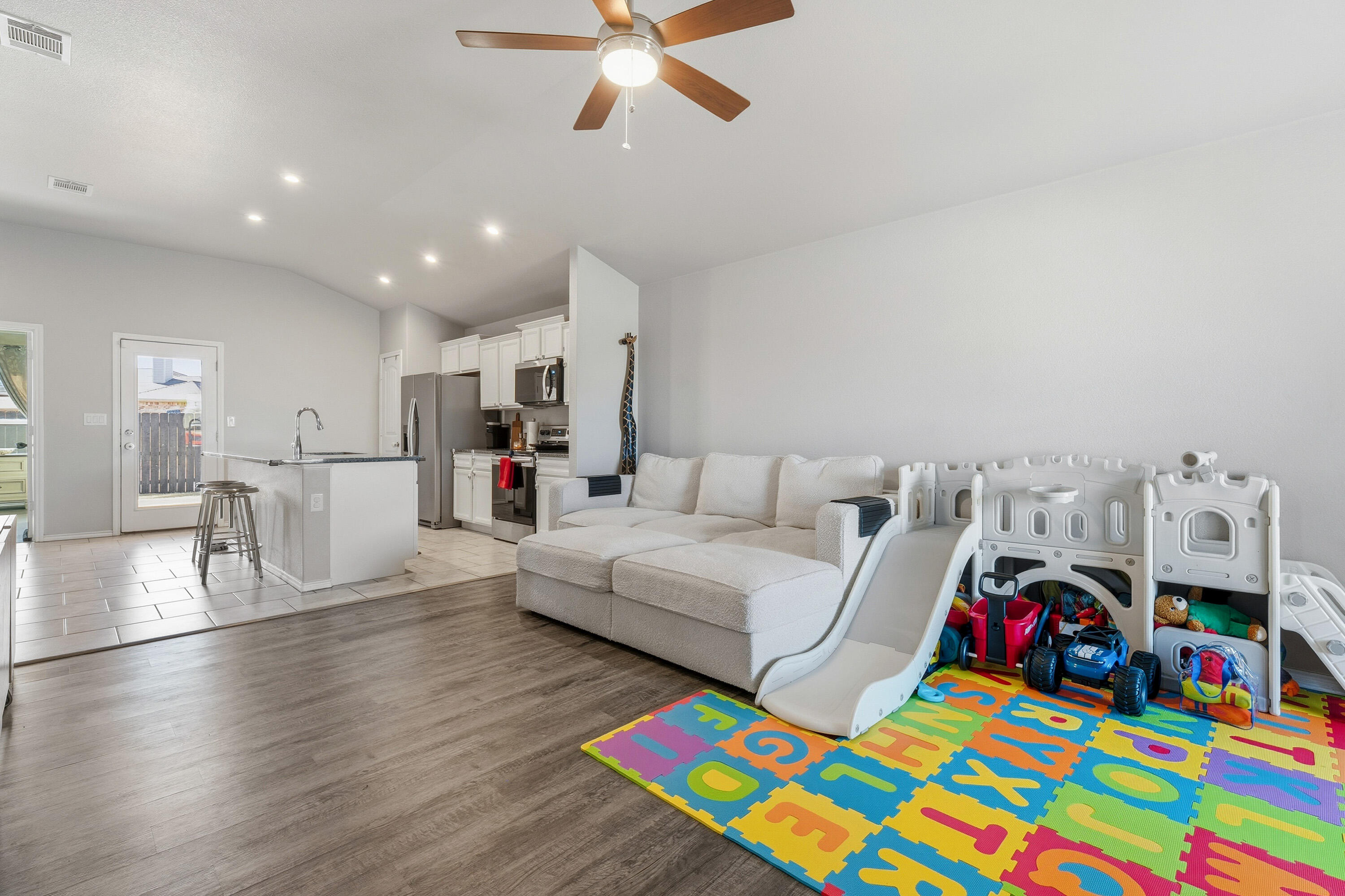 6827 39th Street Lubbock, TX 79407 - Photo 5 of 25 a living room with furniture and a wooden floor