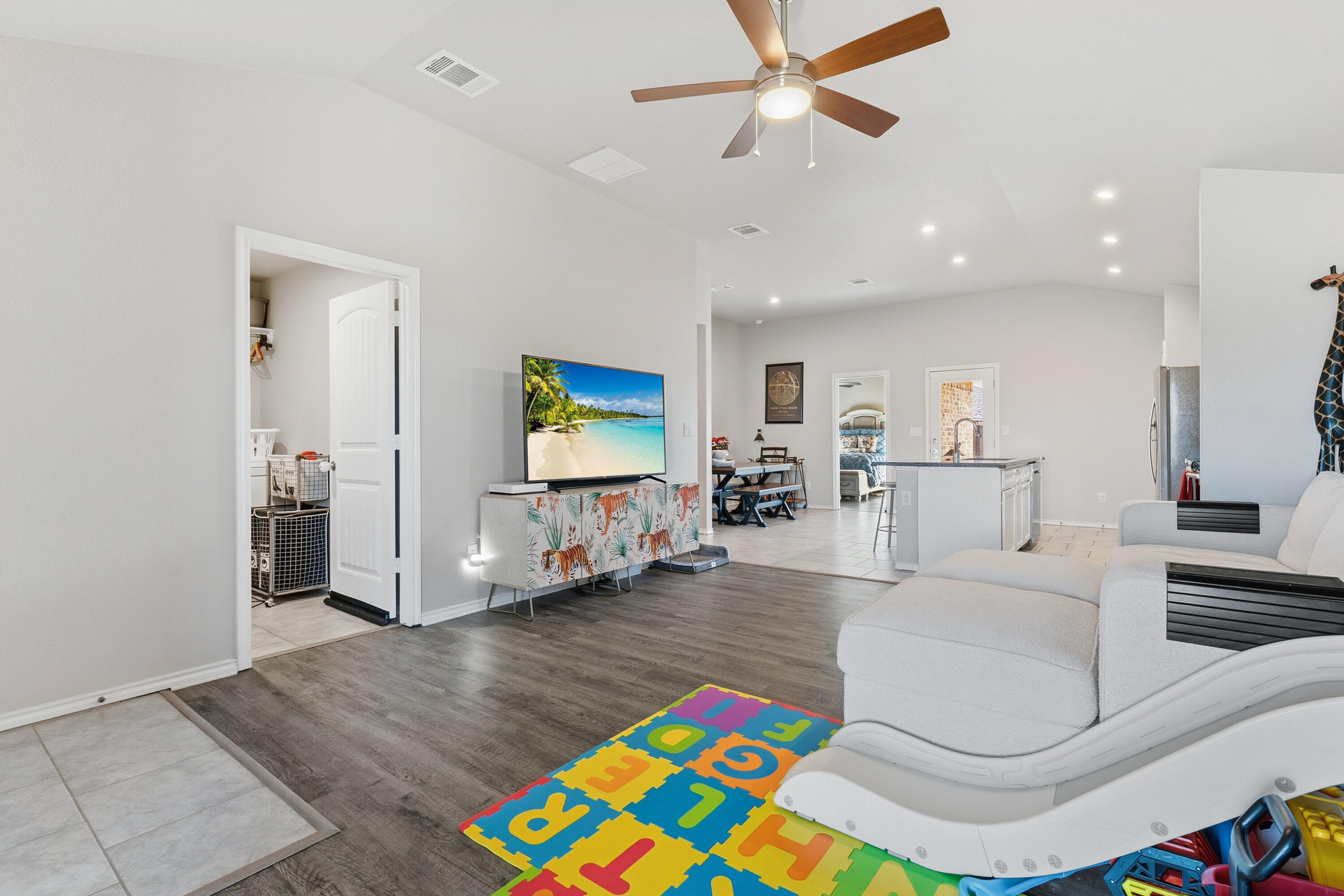 6827 39th Street Lubbock, TX 79407 - Photo 6 of 25 a living room with furniture and a flat screen tv