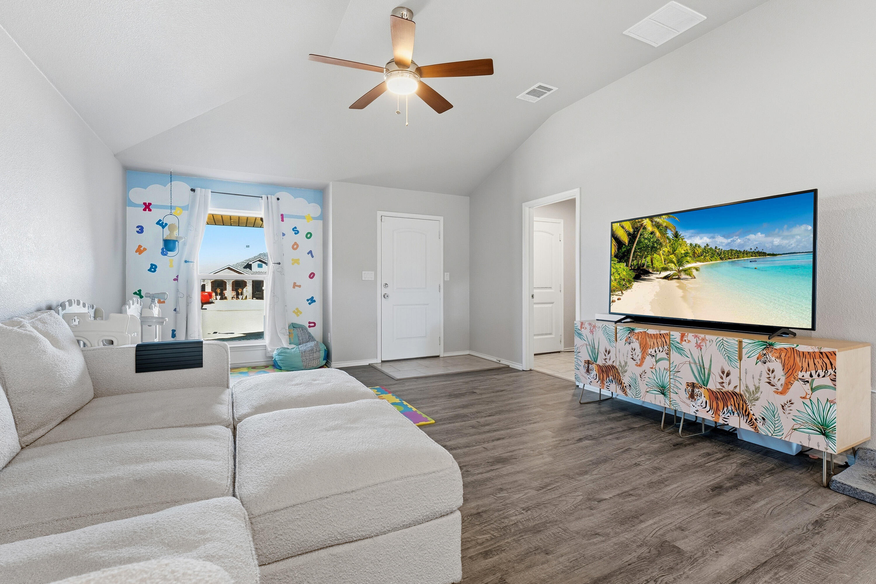 6827 39th Street Lubbock, TX 79407 - Photo 7 of 25 a bedroom with furniture and a flat screen tv