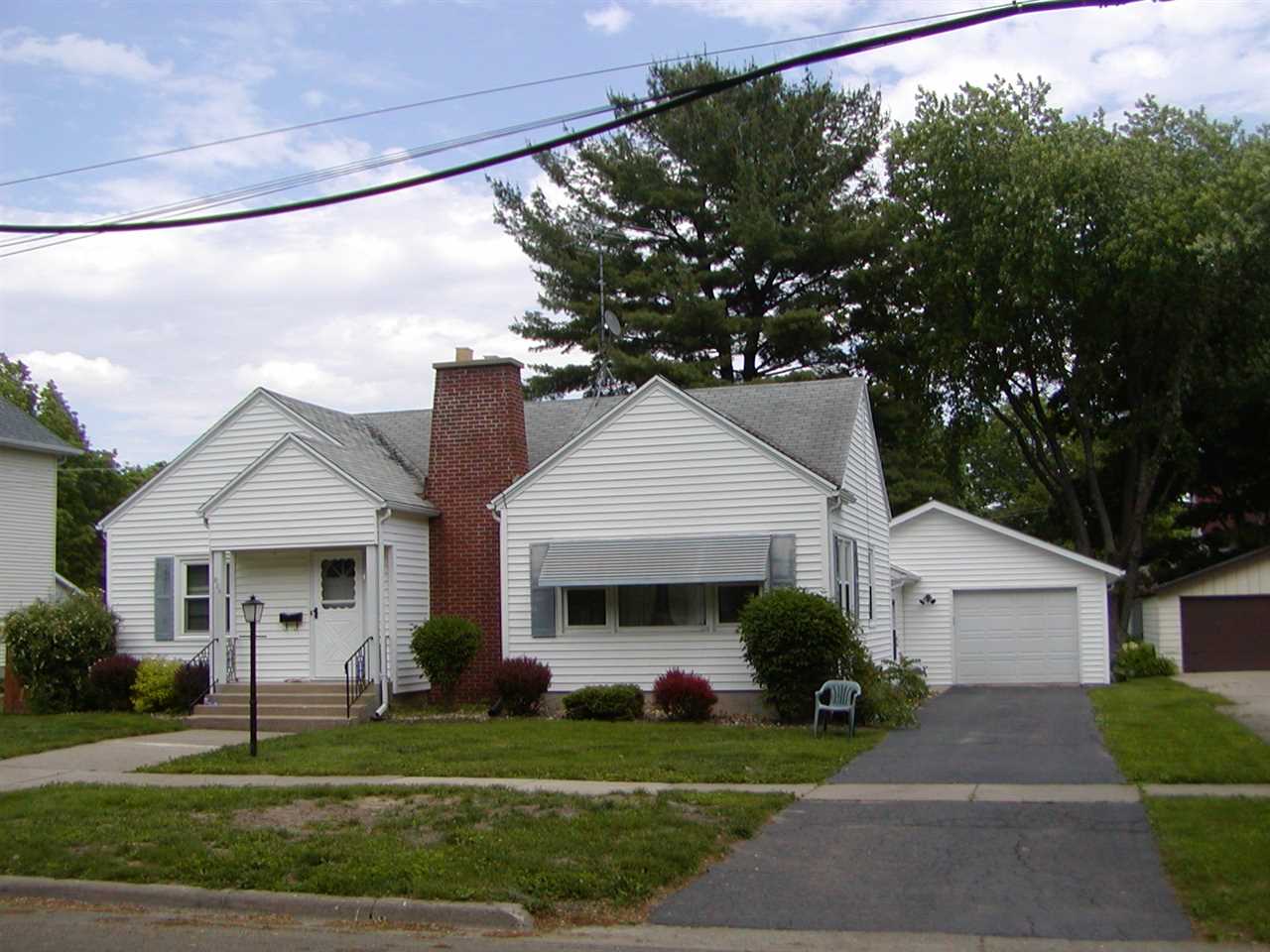 205 South 7th Street Oregon, IL 61061 - Photo 1 of 1 a front view of a house with a garden and trees