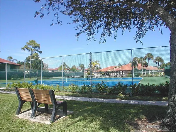 a view of a patio with chairs and a yard