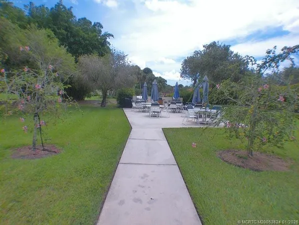a view of yard with swimming pool and green space