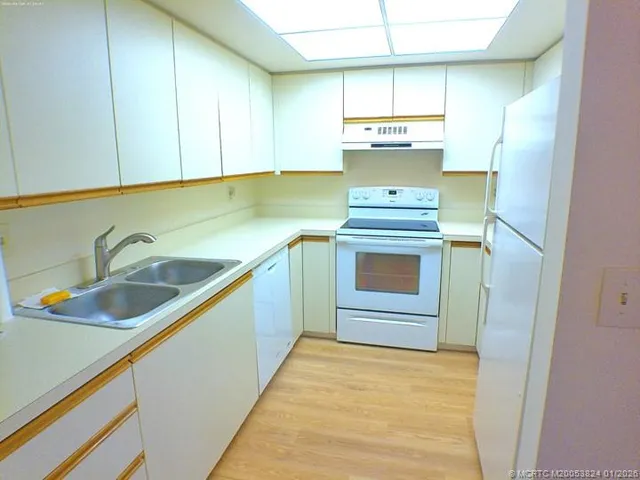 a kitchen with a stove and a sink