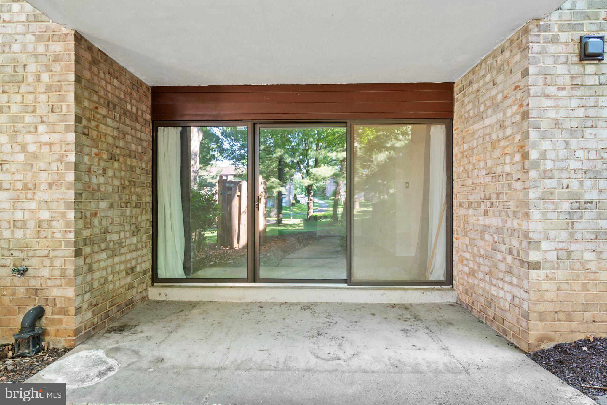 2002 Colts Neck Road, Unit 1A Reston, VA 20191 - Photo 14 of 22 Large sliding door leading to the courtyard