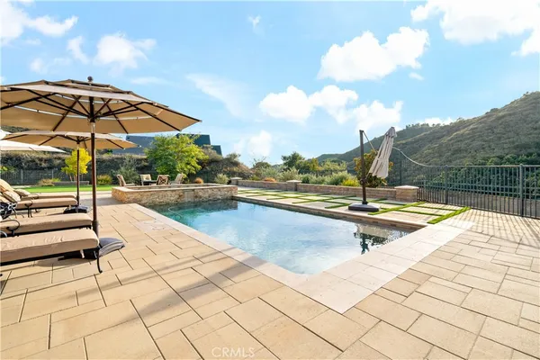 a view of swimming pool with seating area