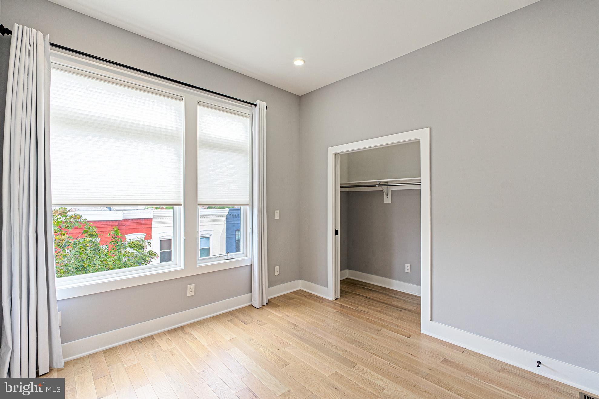 1219 Wylie Street Northeast, Unit 2 Washington, DC 20002 - Photo 17 of 29 an empty room with wooden floor and windows