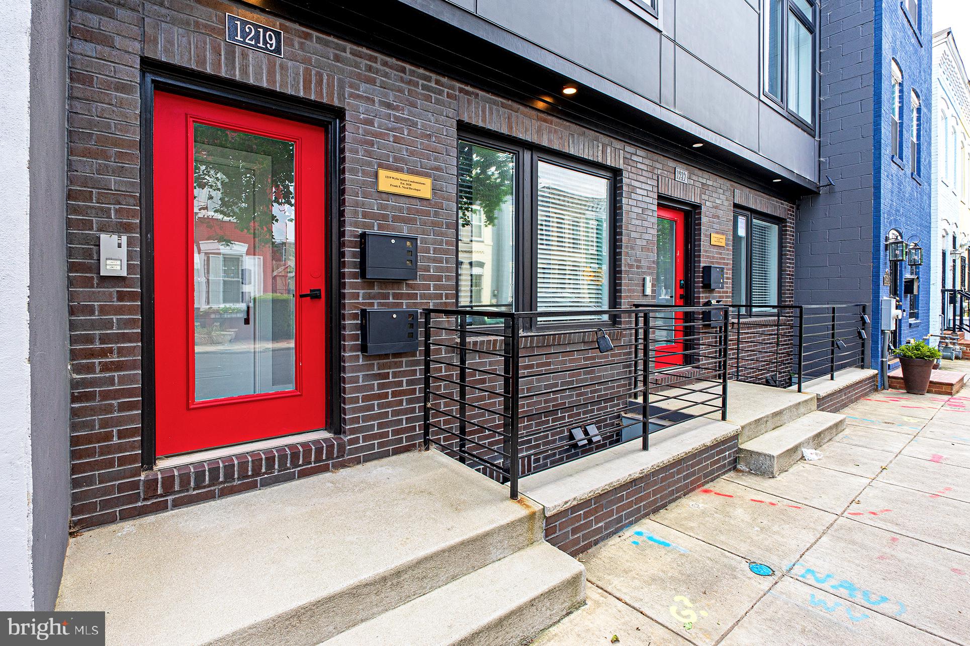 1219 Wylie Street Northeast, Unit 2 Washington, DC 20002 - Photo 2 of 29 a view of a brick building with a red door and a window
