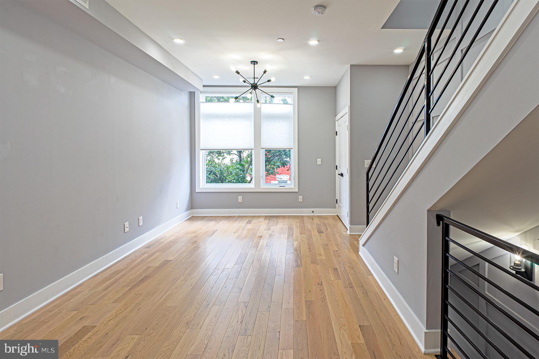 1219 Wylie Street Northeast, Unit 2 Washington, DC 20002 - Photo 5 of 29 wooden floor in an empty room with a window