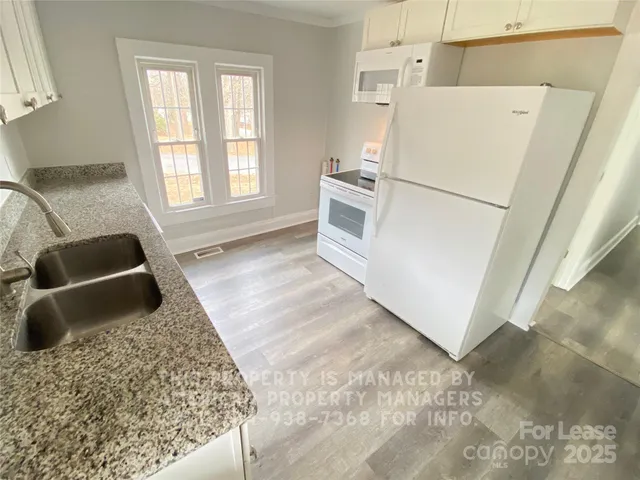 a kitchen with a refrigerator sink and stove