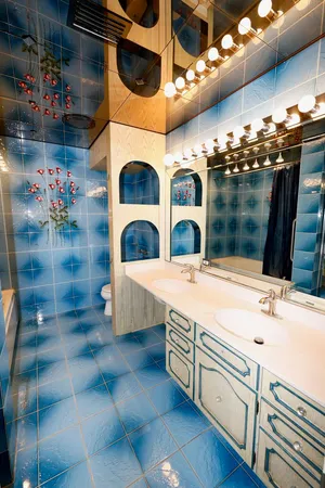 a bathroom with double vanity and a sink