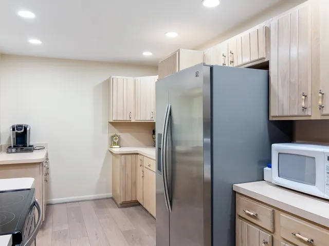 a kitchen with sink a microwave and cabinets