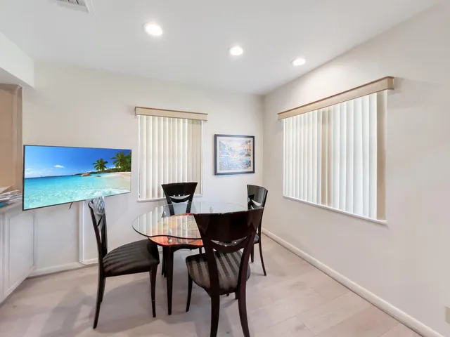 a kitchen with a refrigerator and a stove top oven
