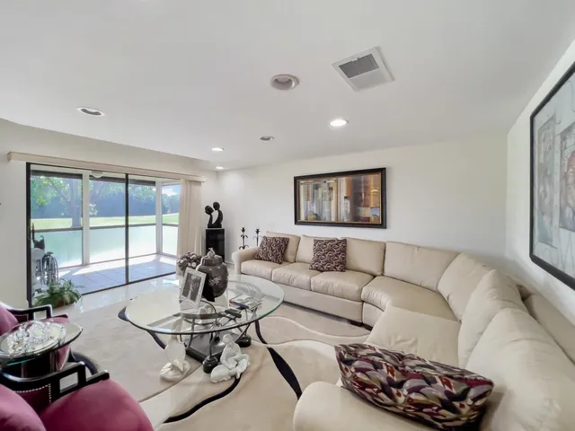 a living room with furniture a window and a table