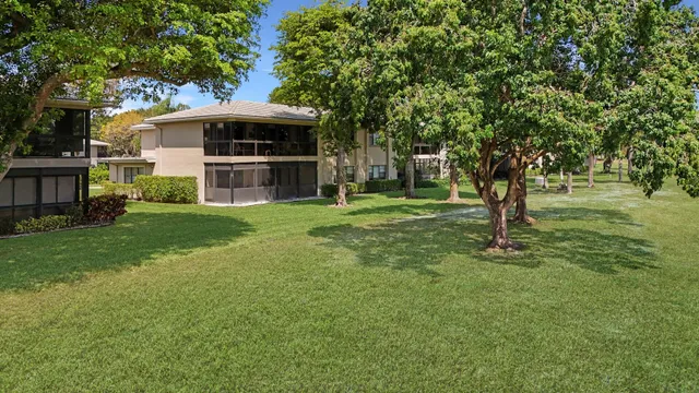 a view of a house with a backyard