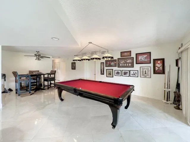 a living room with furniture a couch and paintings on the wall
