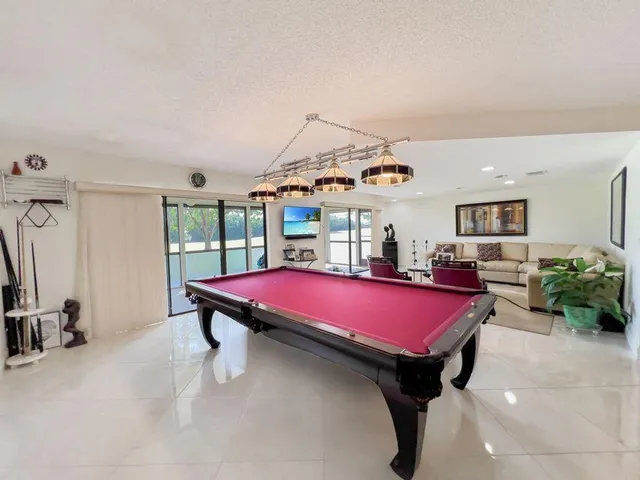 a room with furniture a rug and a chandelier