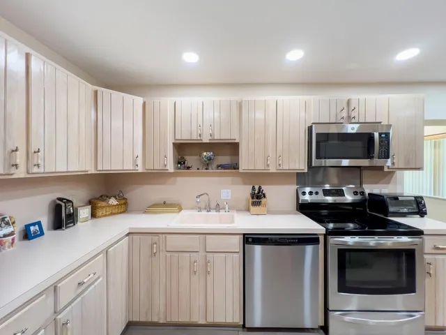 a room with pool table and windows