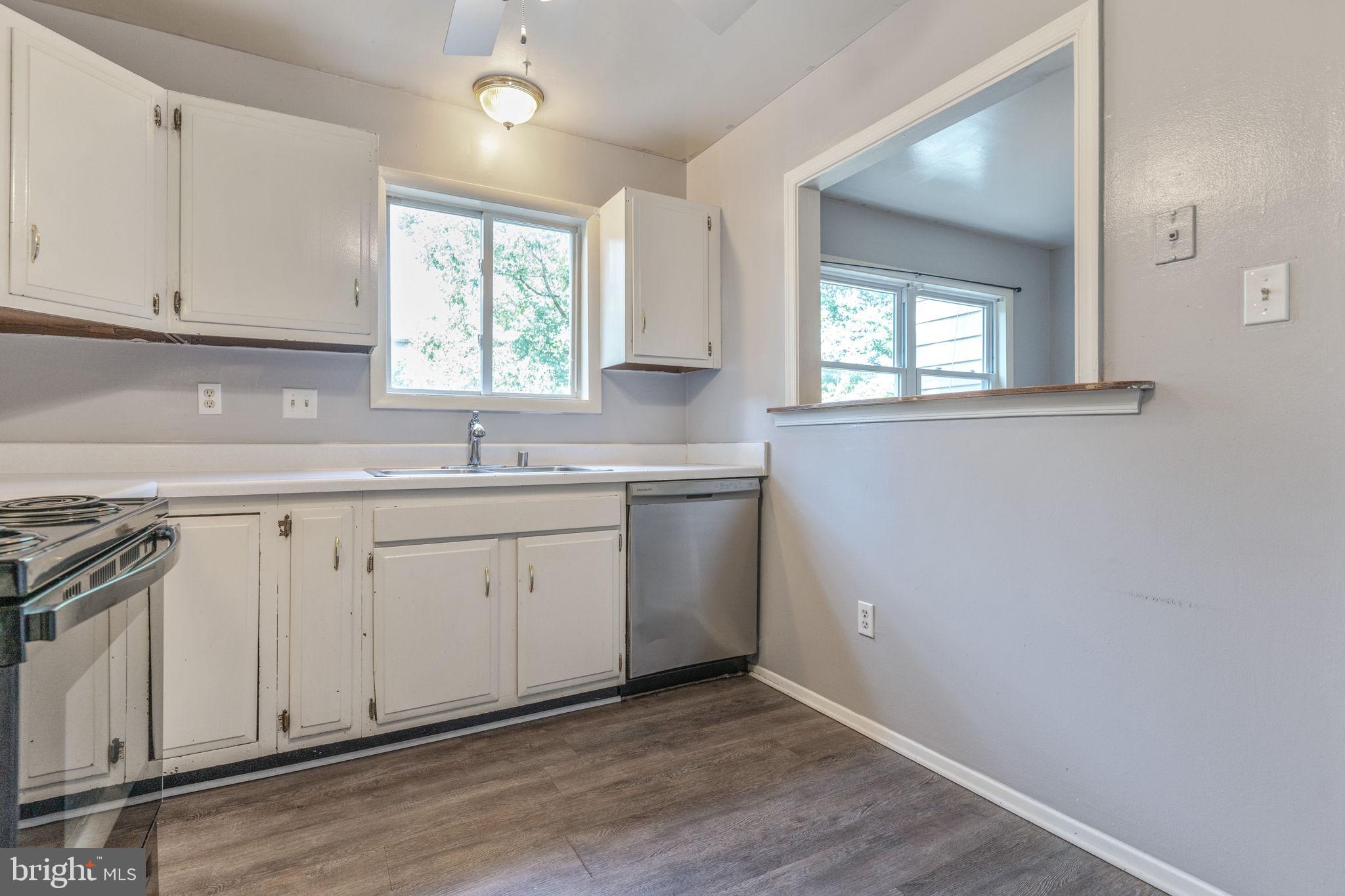 709 Olde Forge Drive Fredericksburg, VA 22405 - Photo 12 of 31 a view of a kitchen with sink and dishwasher with wooden floor
