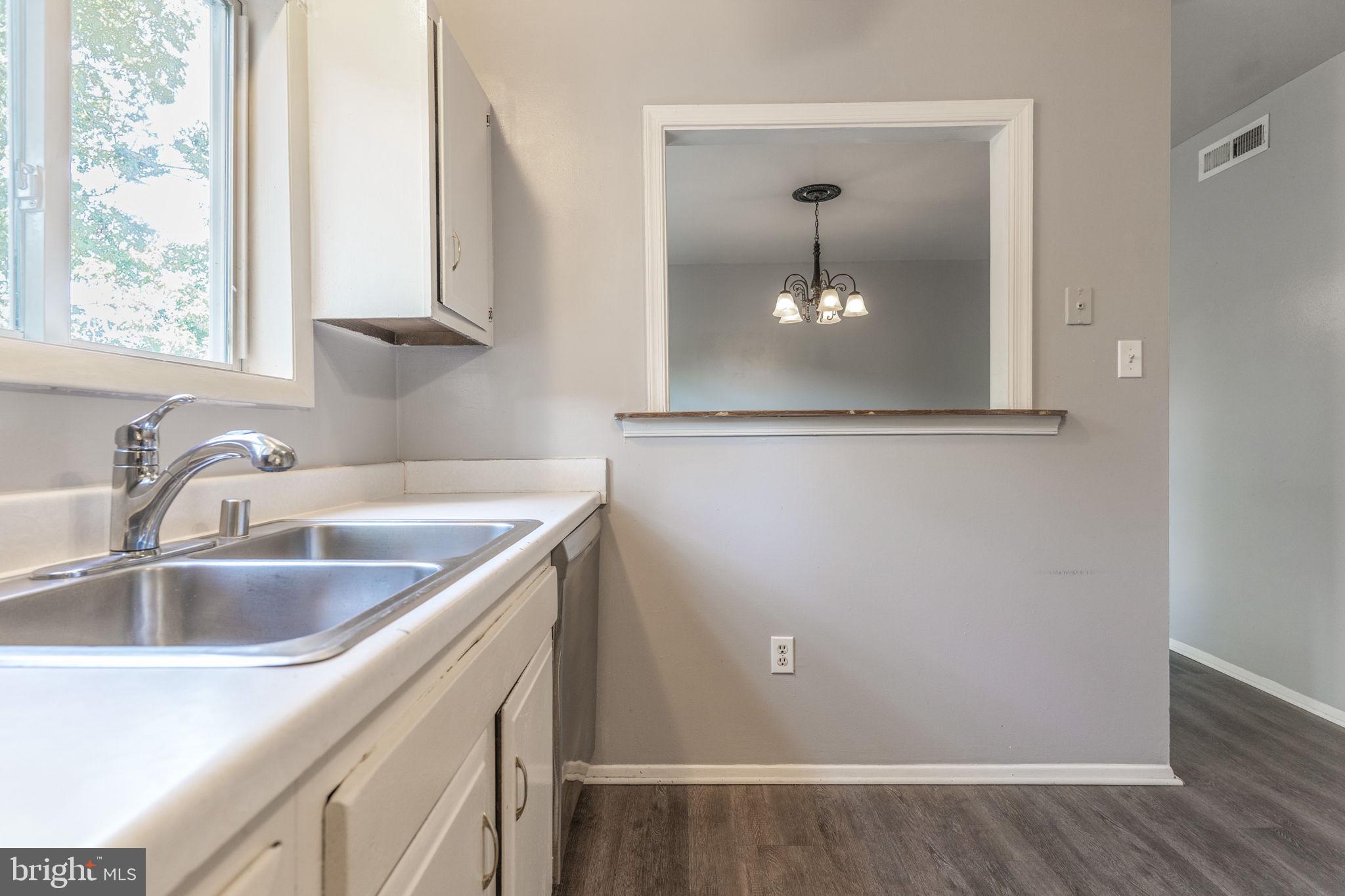 709 Olde Forge Drive Fredericksburg, VA 22405 - Photo 14 of 31 a kitchen with a sink and a mirror