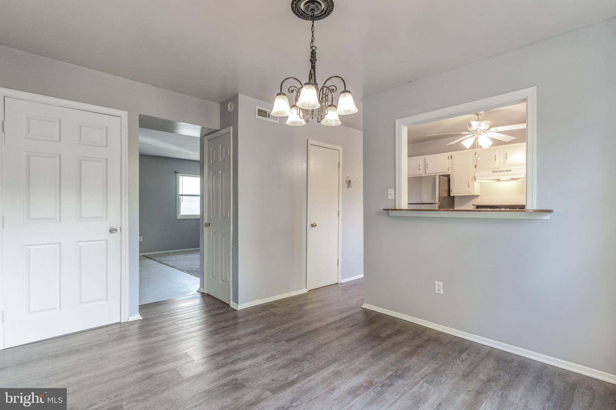 709 Olde Forge Drive Fredericksburg, VA 22405 - Photo 6 of 31 a view of a room with wooden floor and chandelier