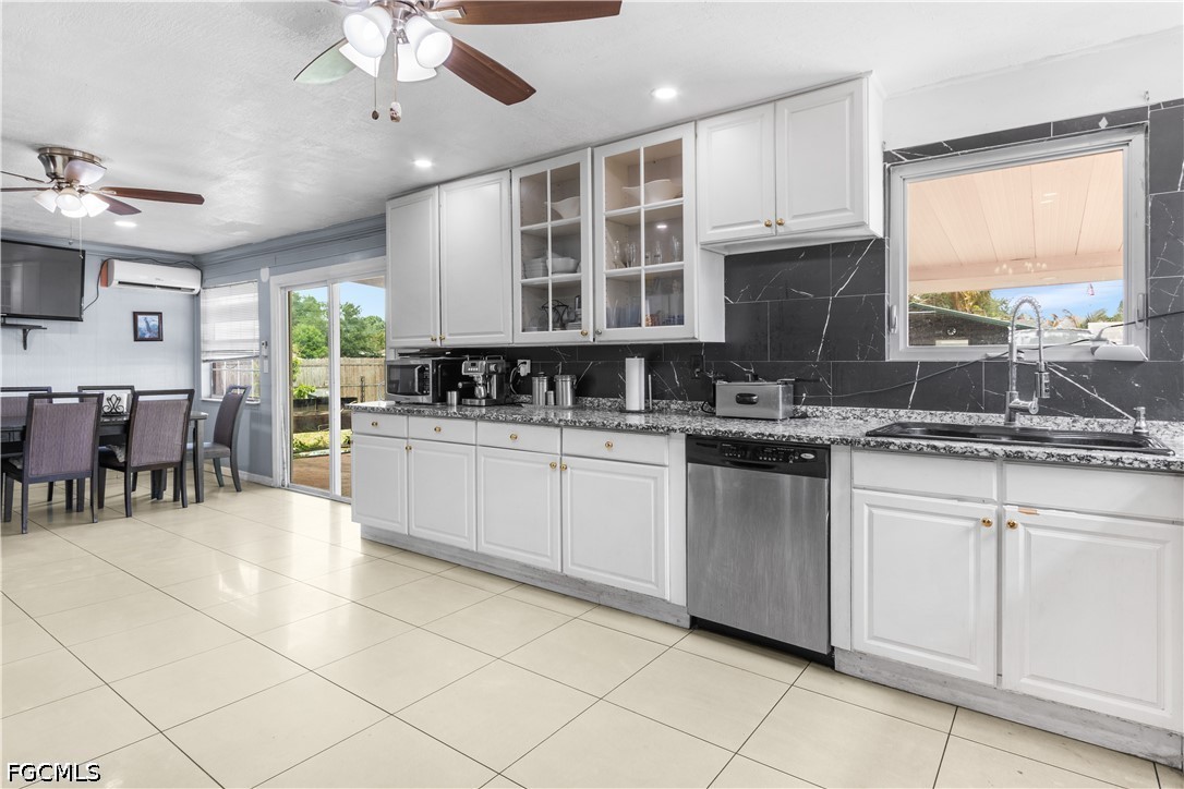 18 Illinois Road Lehigh Acres, FL 33936 - Photo 18 of 45 a kitchen with stainless steel appliances granite countertop a stove sink and cabinets