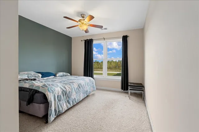 a bed sitting in a room next to a window