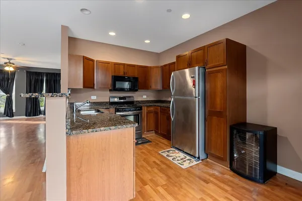 a kitchen with stainless steel appliances granite countertop a refrigerator stove and oven