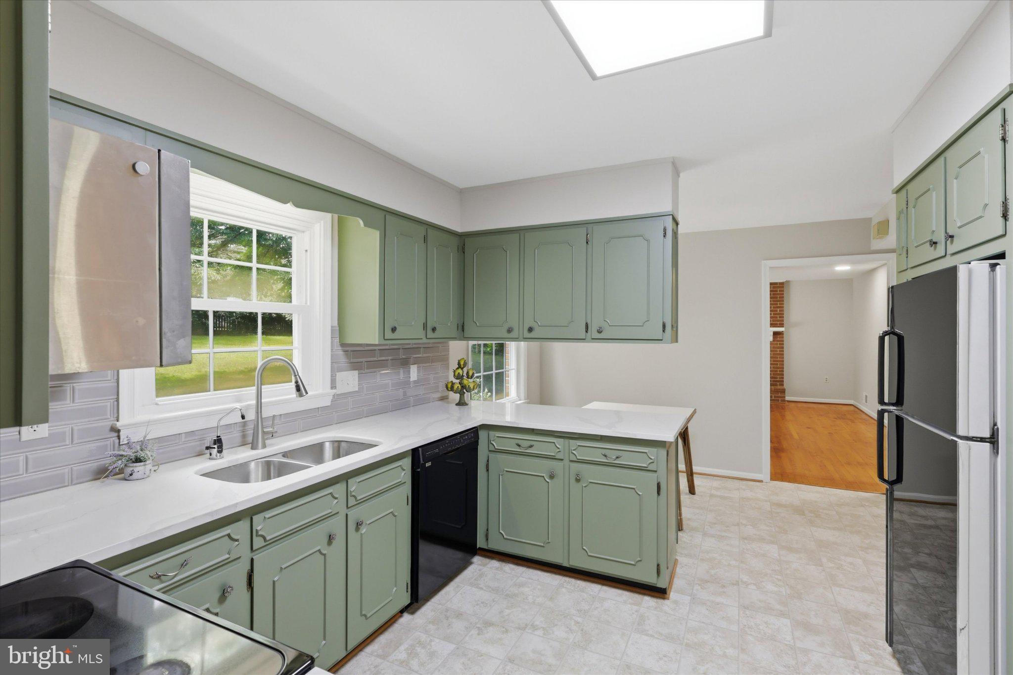 7007 Runnymeade Court Frederick, MD 21702 - Photo 9 of 37 Charming kitchen with green cabinetry.