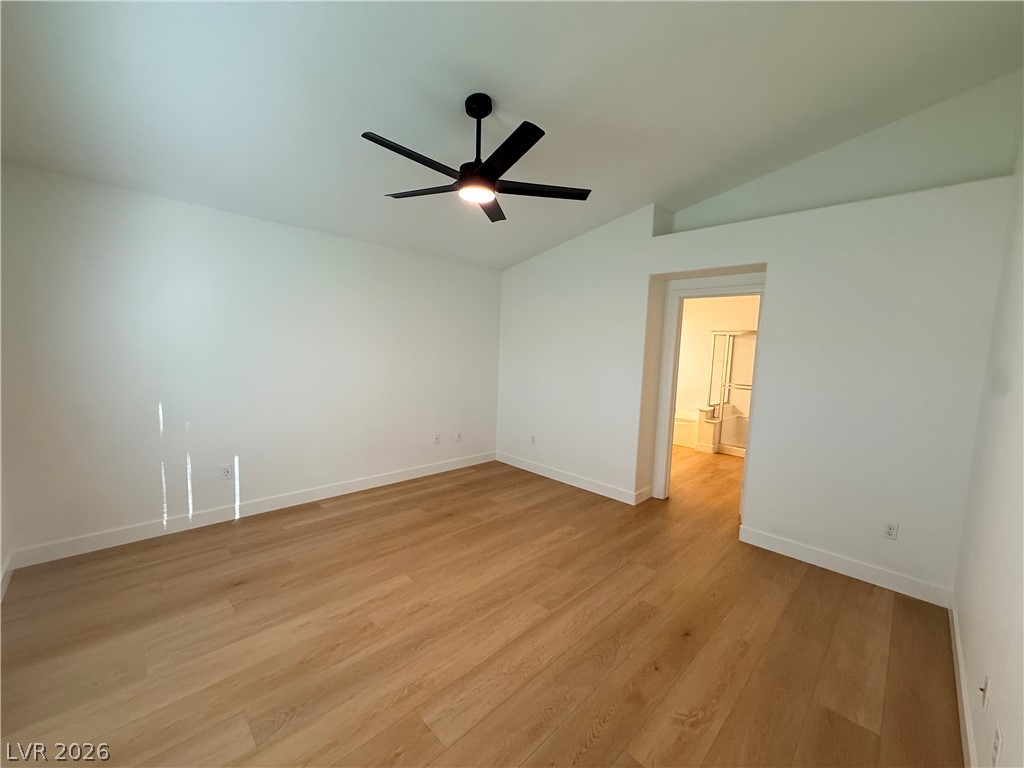 2122 Hidden Ranch Terrace Henderson, NV 89052 - Photo 15 of 20 A well-lit bedroom with modern flooring and a direct view into an adjoining bath.