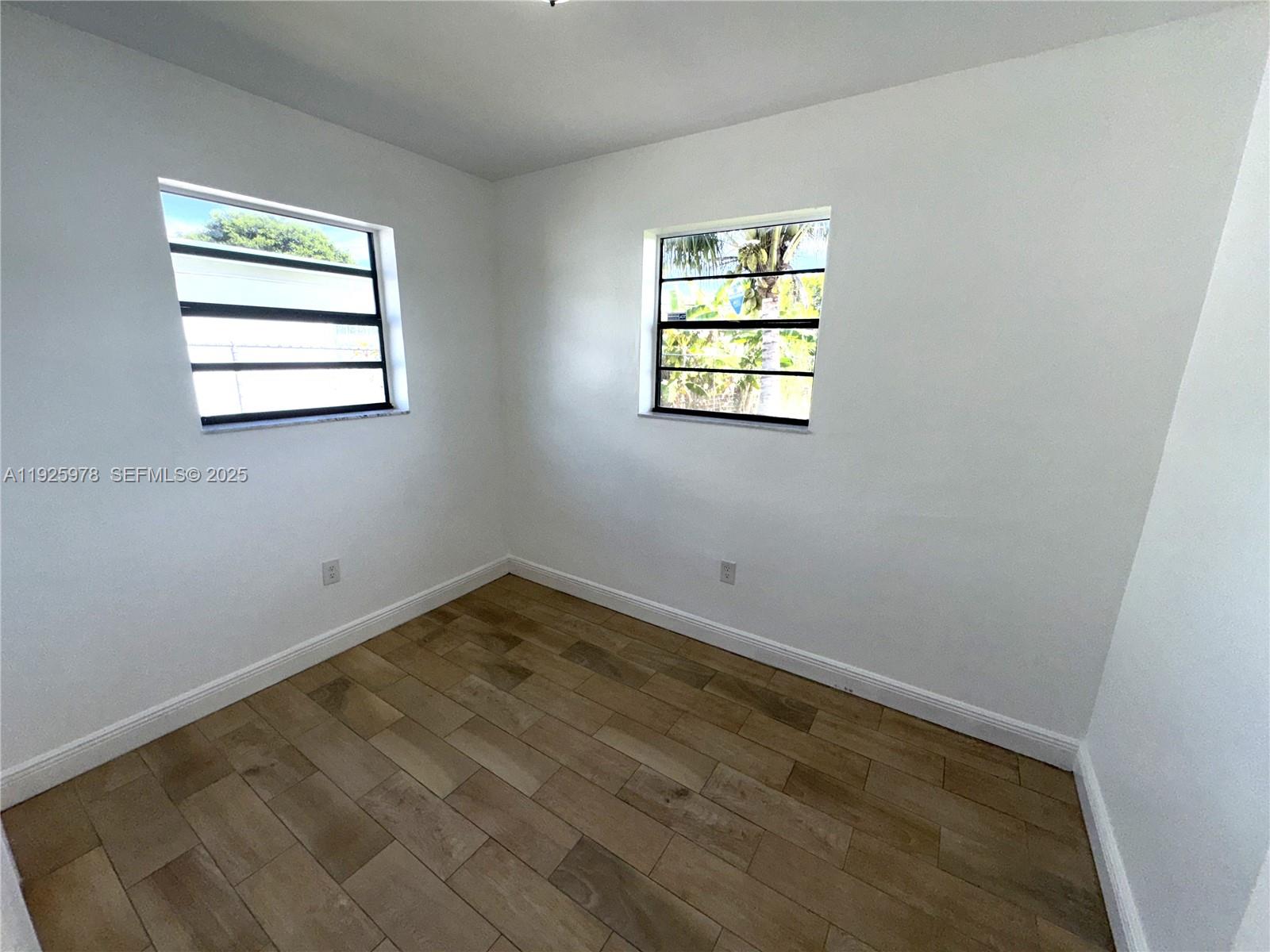 10840 Southwest 222nd Drive Miami, FL 33170 - Photo 12 of 21 an empty room with windows