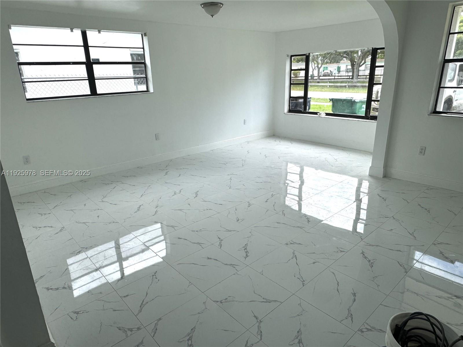 10840 Southwest 222nd Drive Miami, FL 33170 - Photo 4 of 21 an empty room that has a window in it