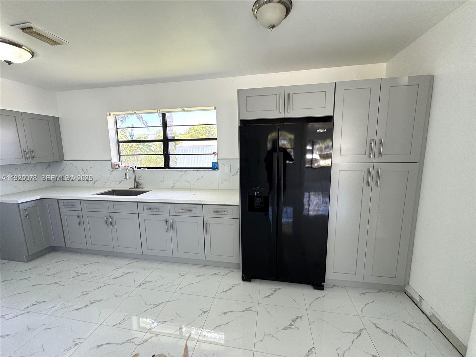 10840 Southwest 222nd Drive Miami, FL 33170 - Photo 5 of 21 a kitchen with a refrigerator and window