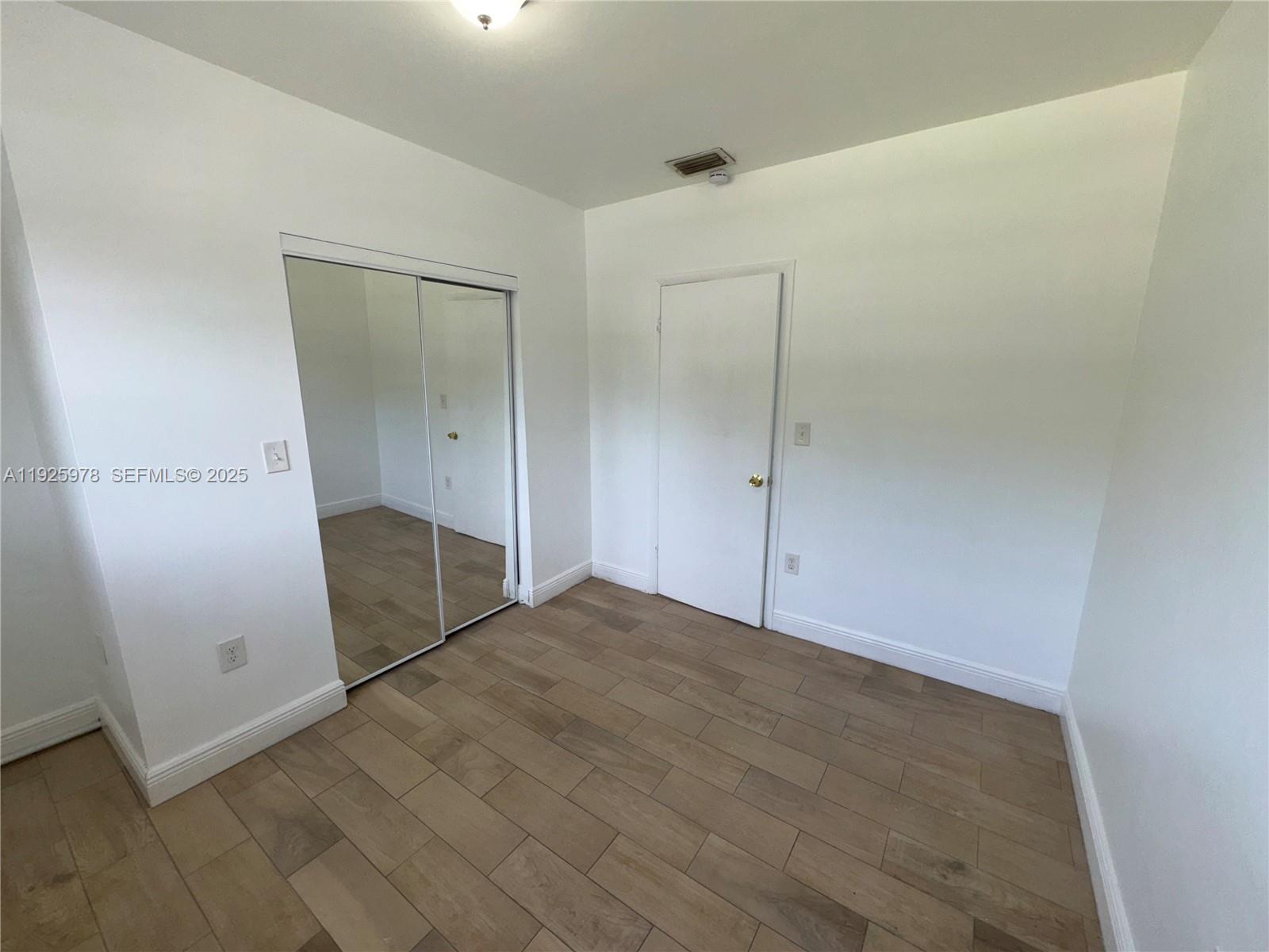 10840 Southwest 222nd Drive Miami, FL 33170 - Photo 9 of 21 an empty room with mirror