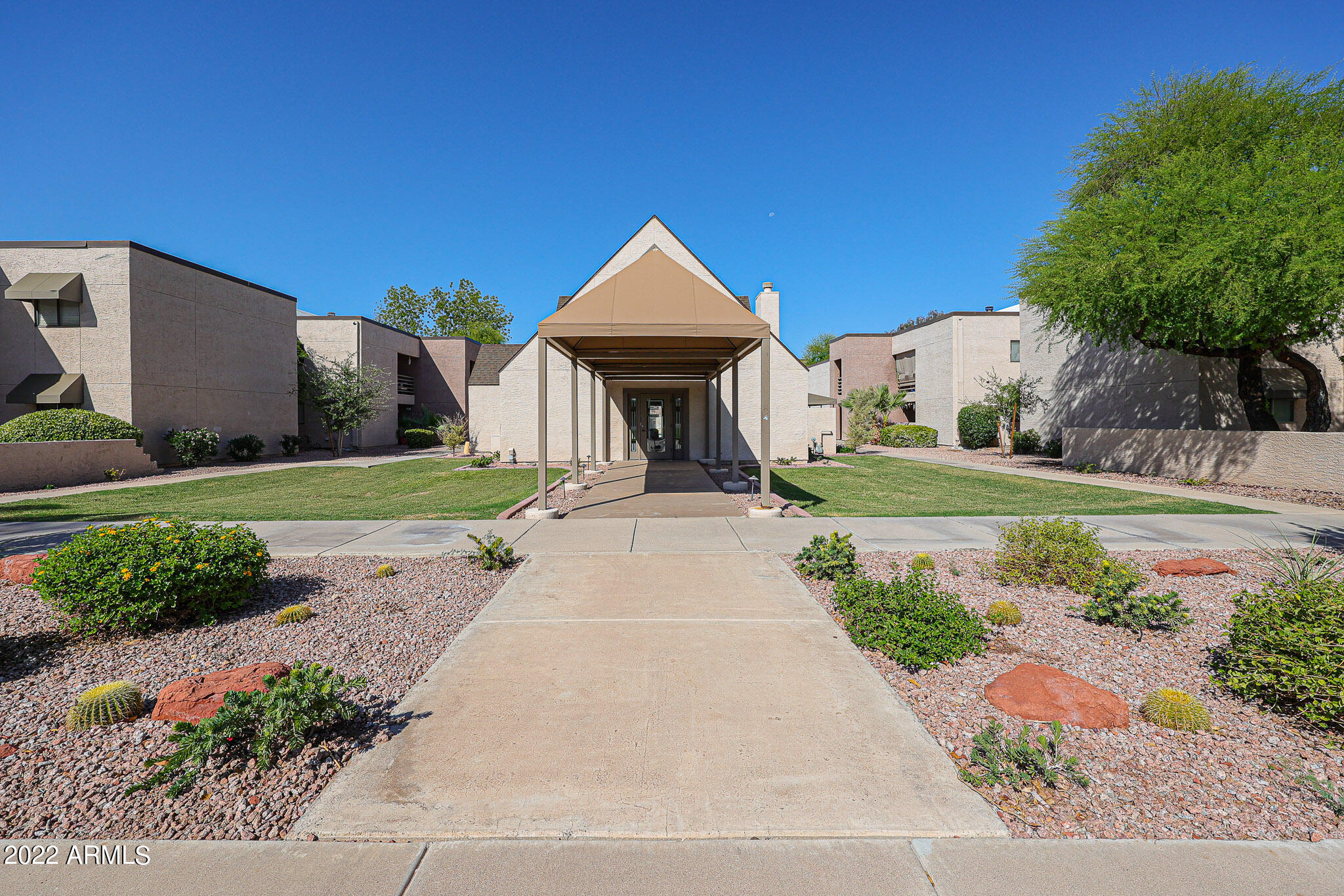 1340 North Recker Road, Unit 141 Mesa, AZ 85205 - Photo 16 of 17 a view of a house with a yard