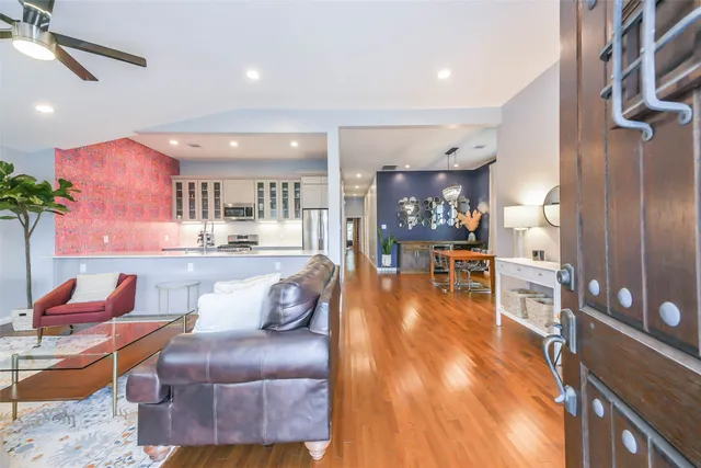 a living room with furniture and a wooden floor
