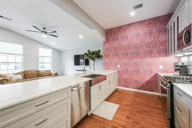 a kitchen with a sink appliances and cabinets