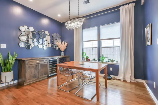 a view of a dining room with furniture a chandelier and wooden floor